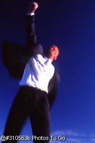Exuberant businessman jumping in the air